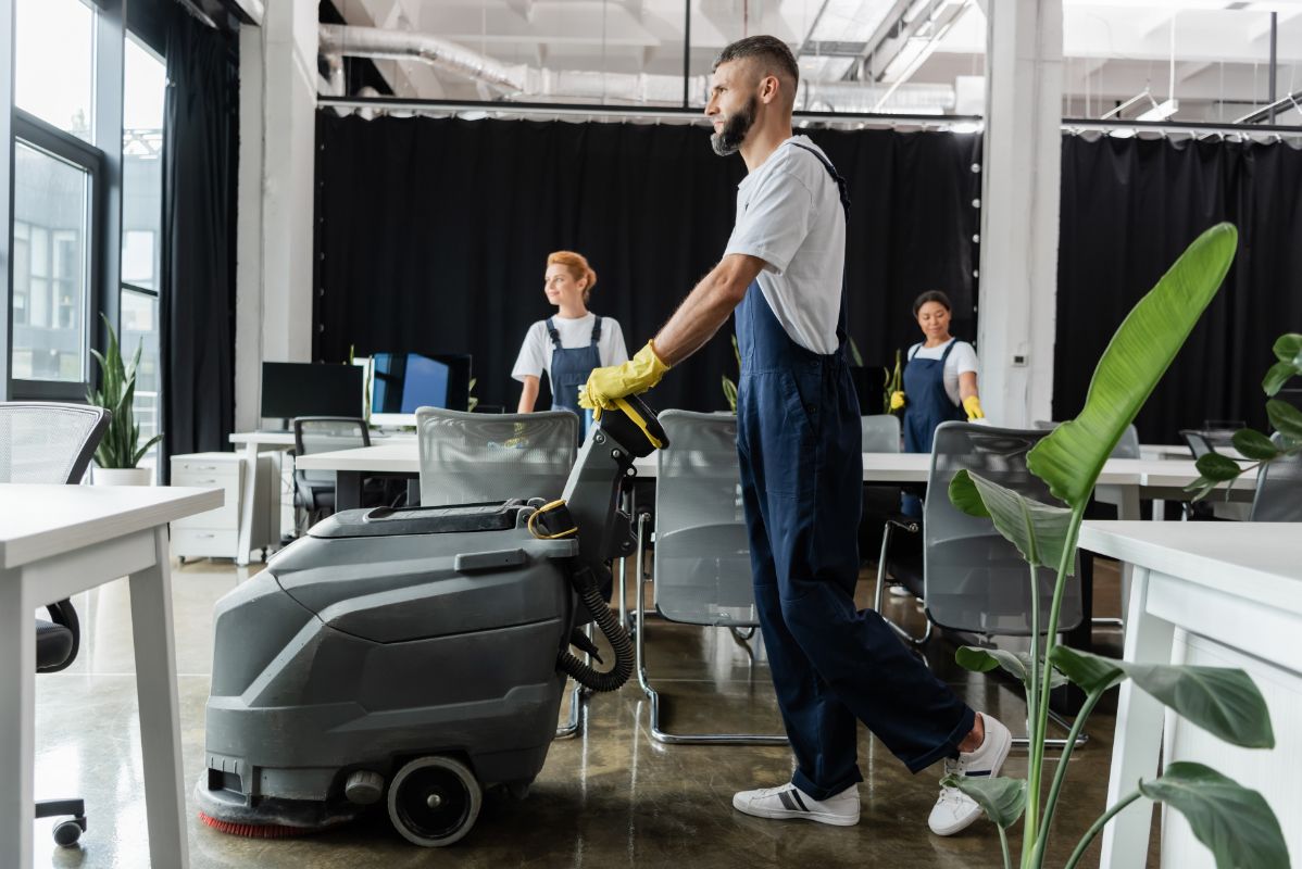 bearded man with electrical floor scrubber machine 2026 03 08 22 55 38 utc